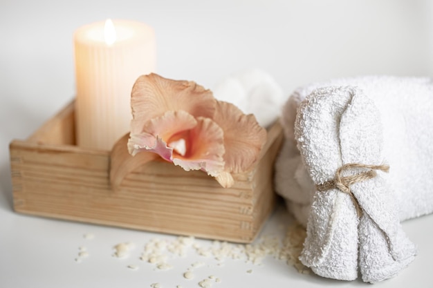 Free photo spa composition with body care products in a wooden box and thai orchid flowers