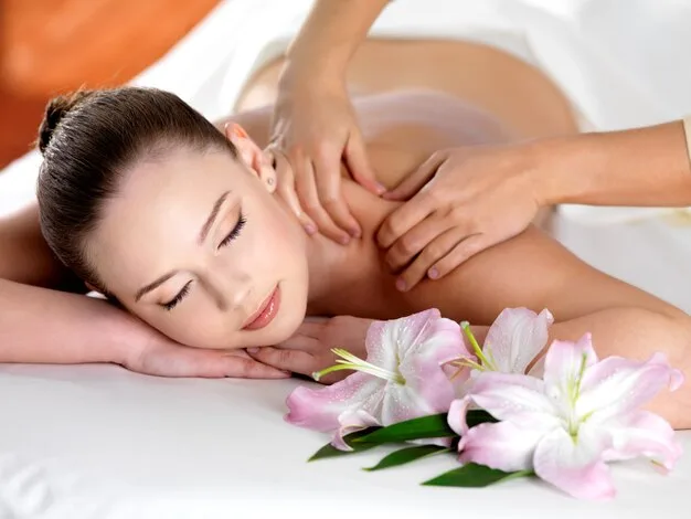 Spa massage on a shoulder for young beautiful woman in beauty salon
